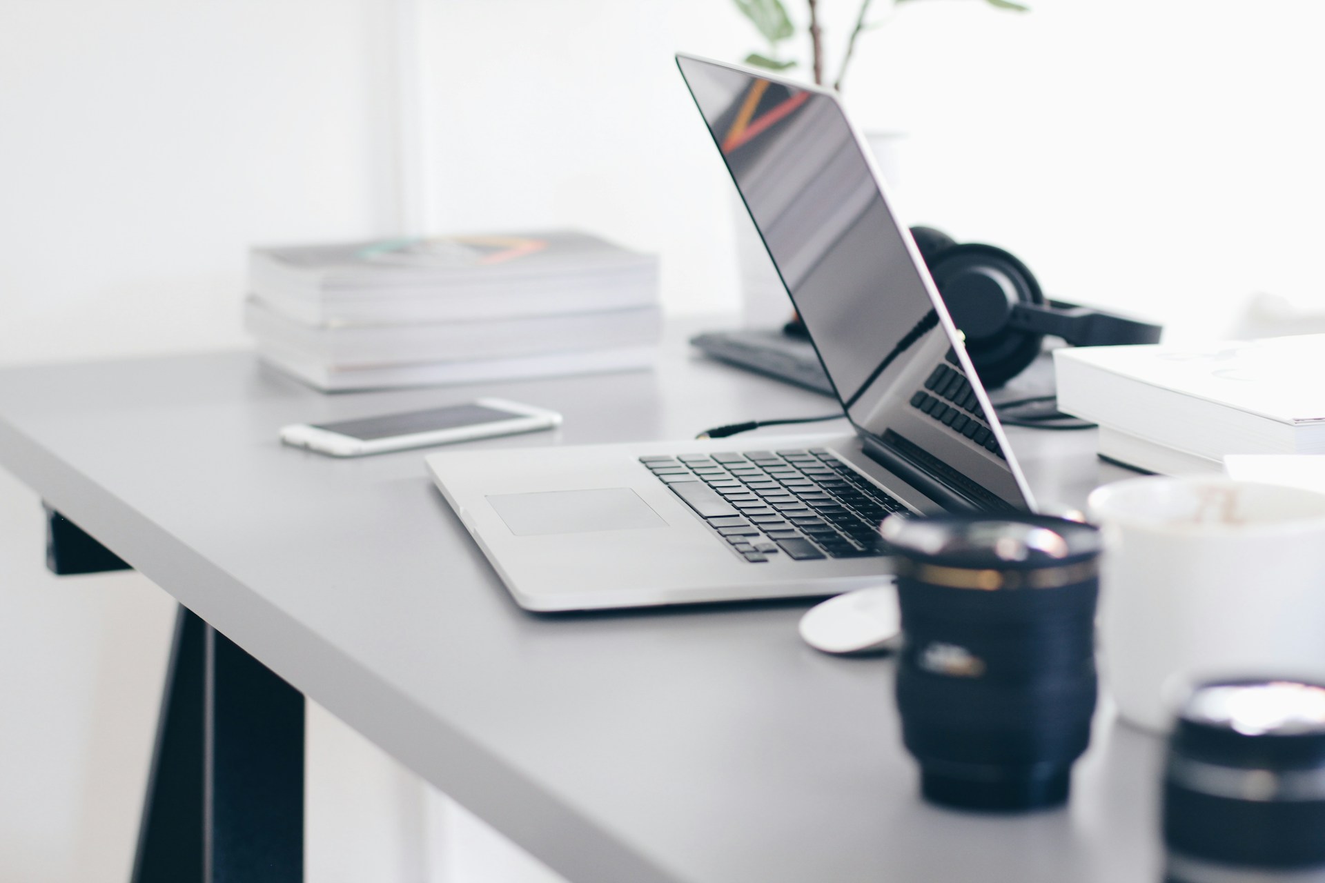 Computer, books, and cellphone on a desk